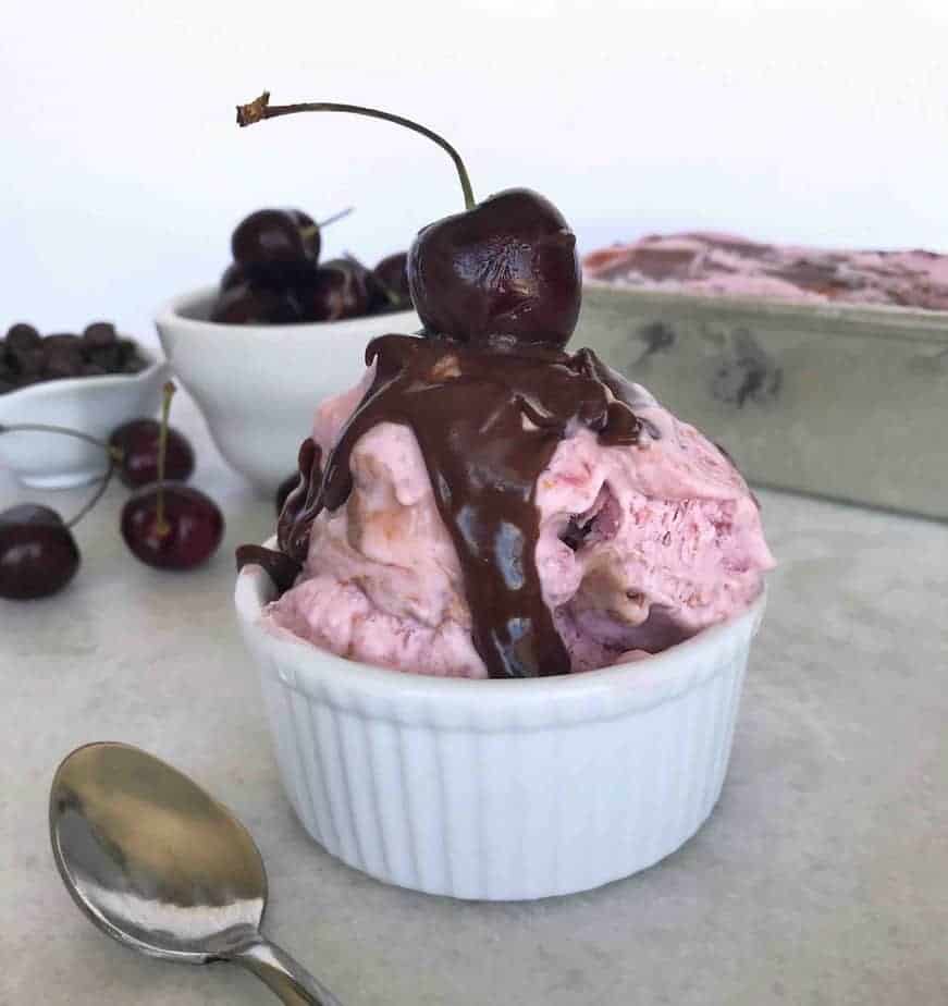 scoop of cherry ice cream with chocolate sauce on top