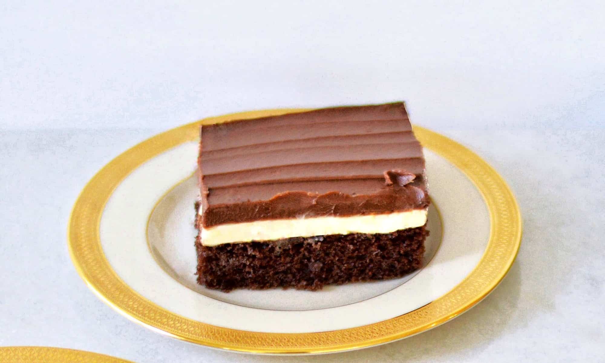 slice of Ho Ho cake: chocolate cake with layer of cream and ganache