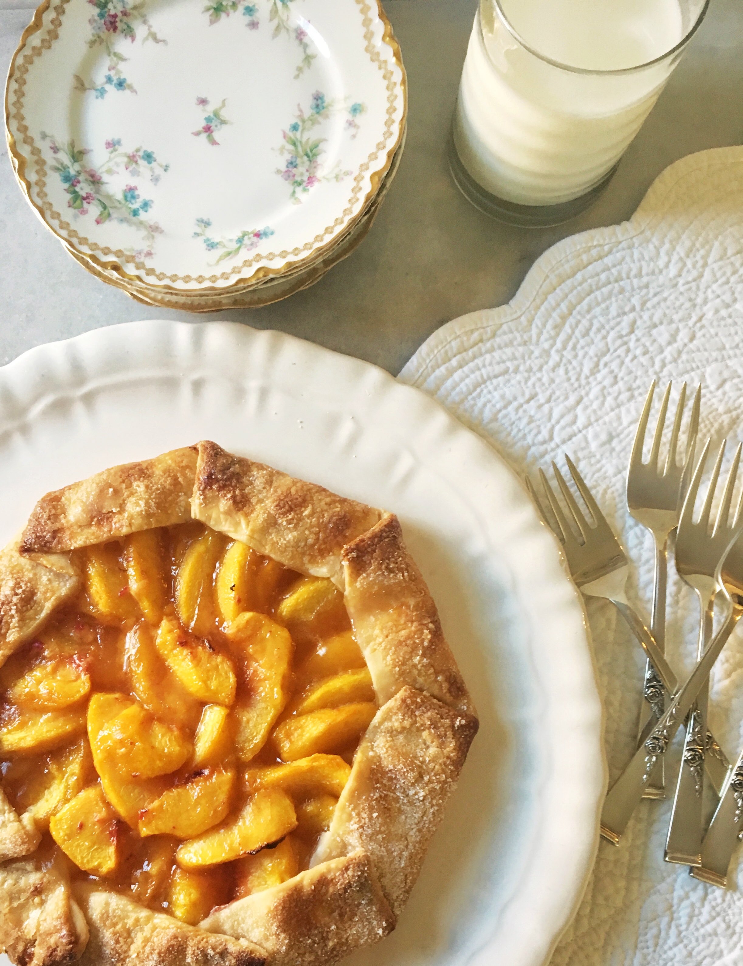 Peach Galette with serving plates and forks