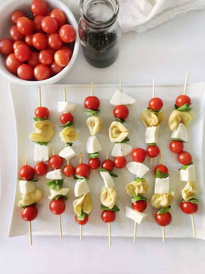 skewers with mozzarella, tortellini pasta, basil and tomatoes