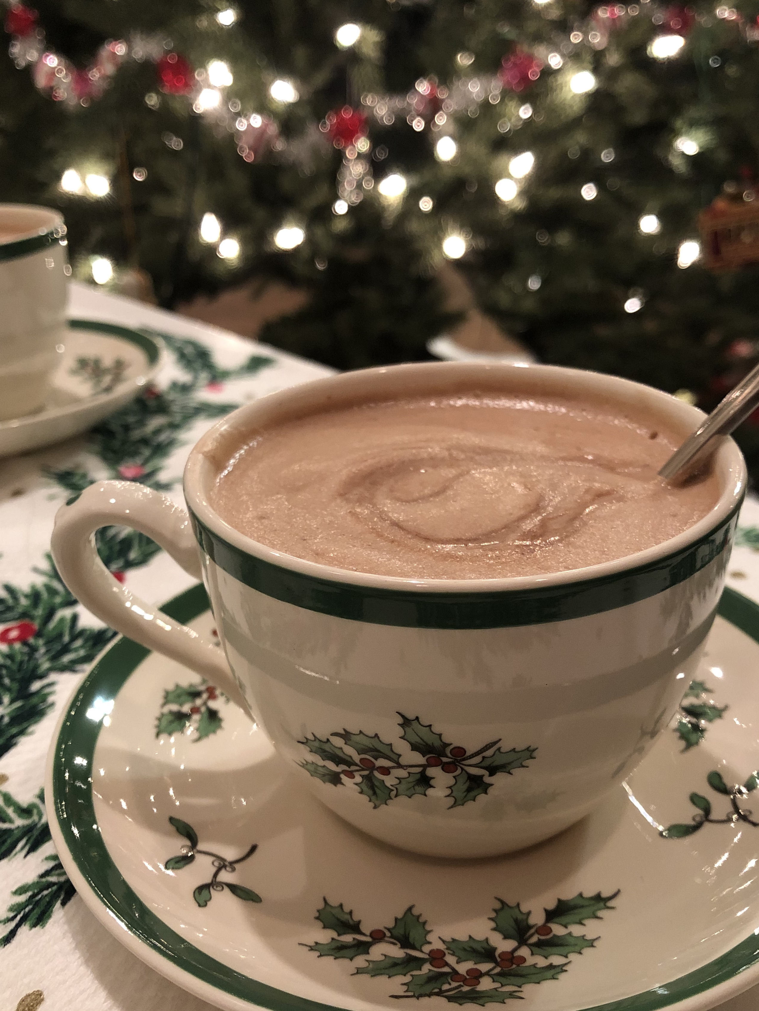 French Hot Chocolate in a Christmas cup by a Christmas tree