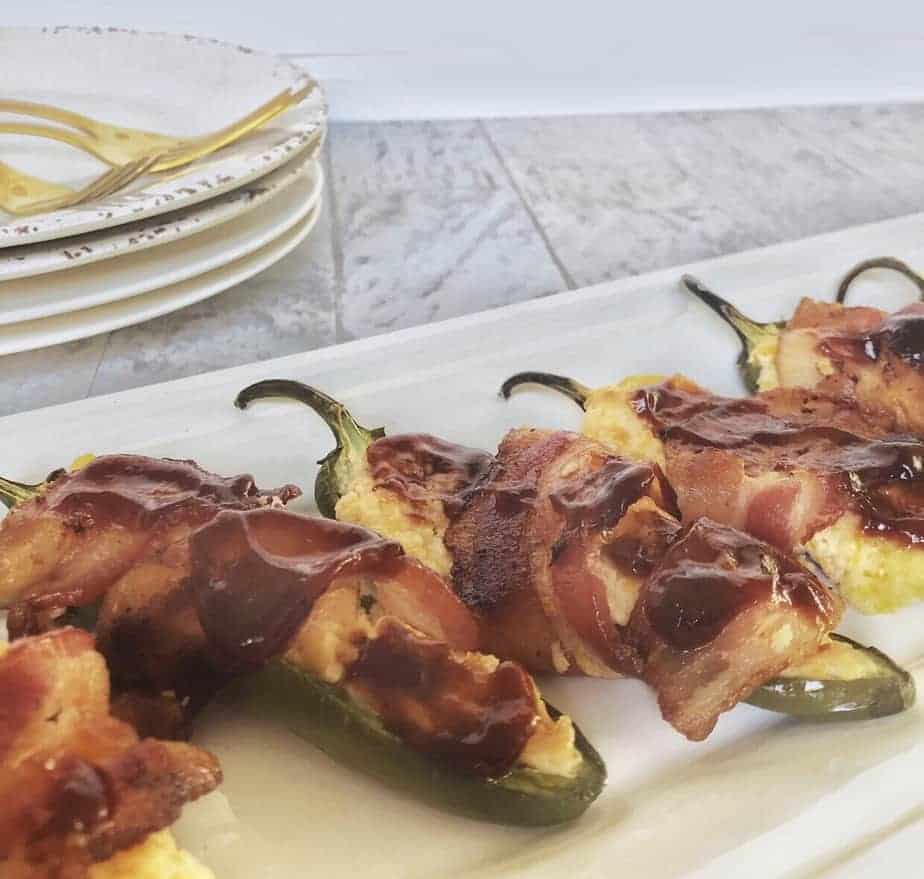 bacon wrapped jalapeno poppers on white tray