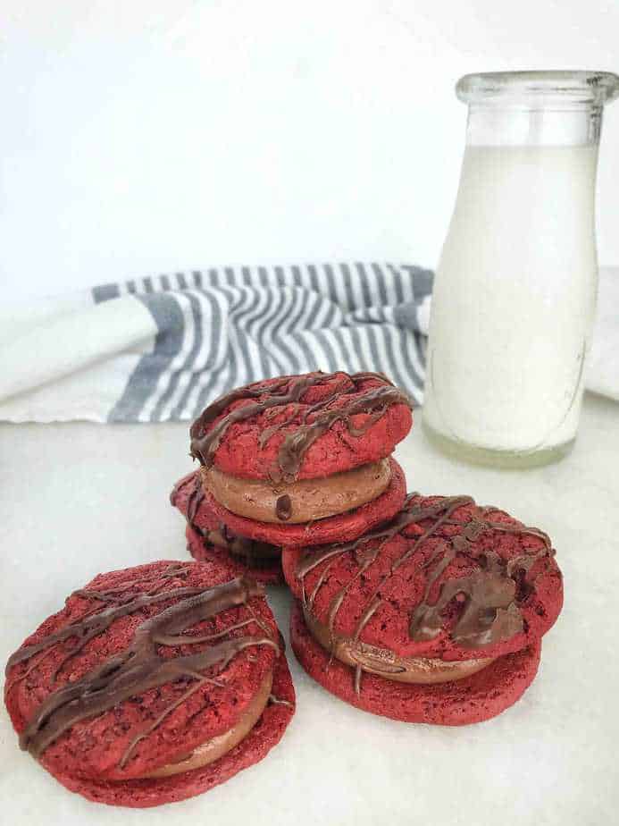 4 red velvet cookie sandwiches with bottle of milk