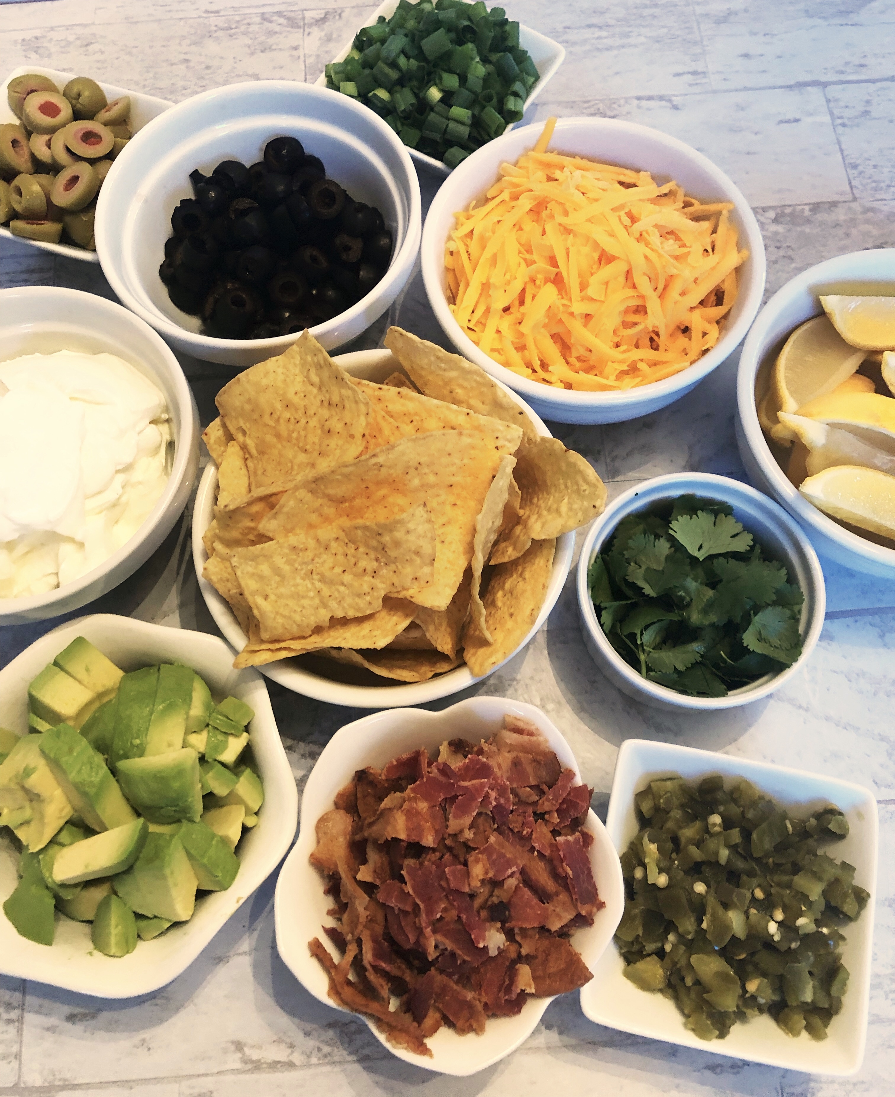 a delicious array of toppings from avocados to jalapeños, cheddar cheese and sour cream
