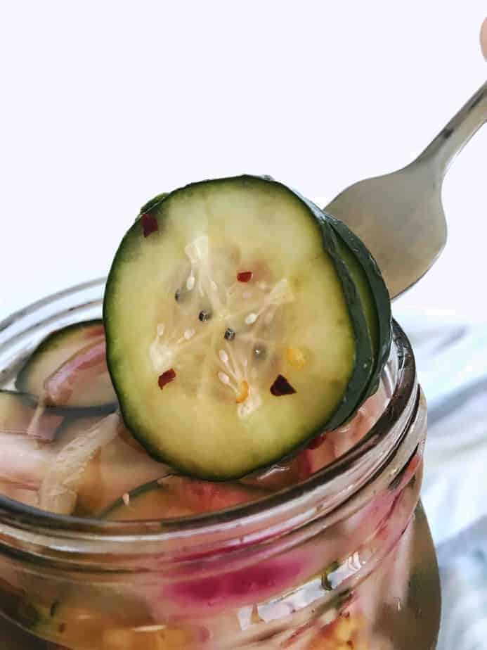 pickle slice on fork over open jar