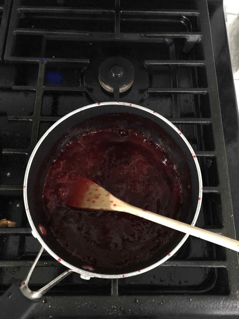 raspberry sauce in a saucepan for raspberry cream crepe cake