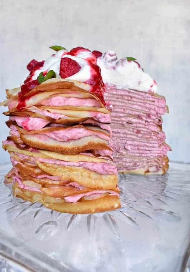 Raspberry cream crepe cake with slice missing