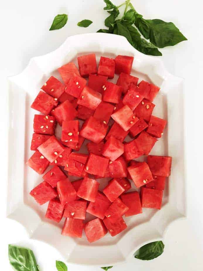 large white platter with watermelon chunks