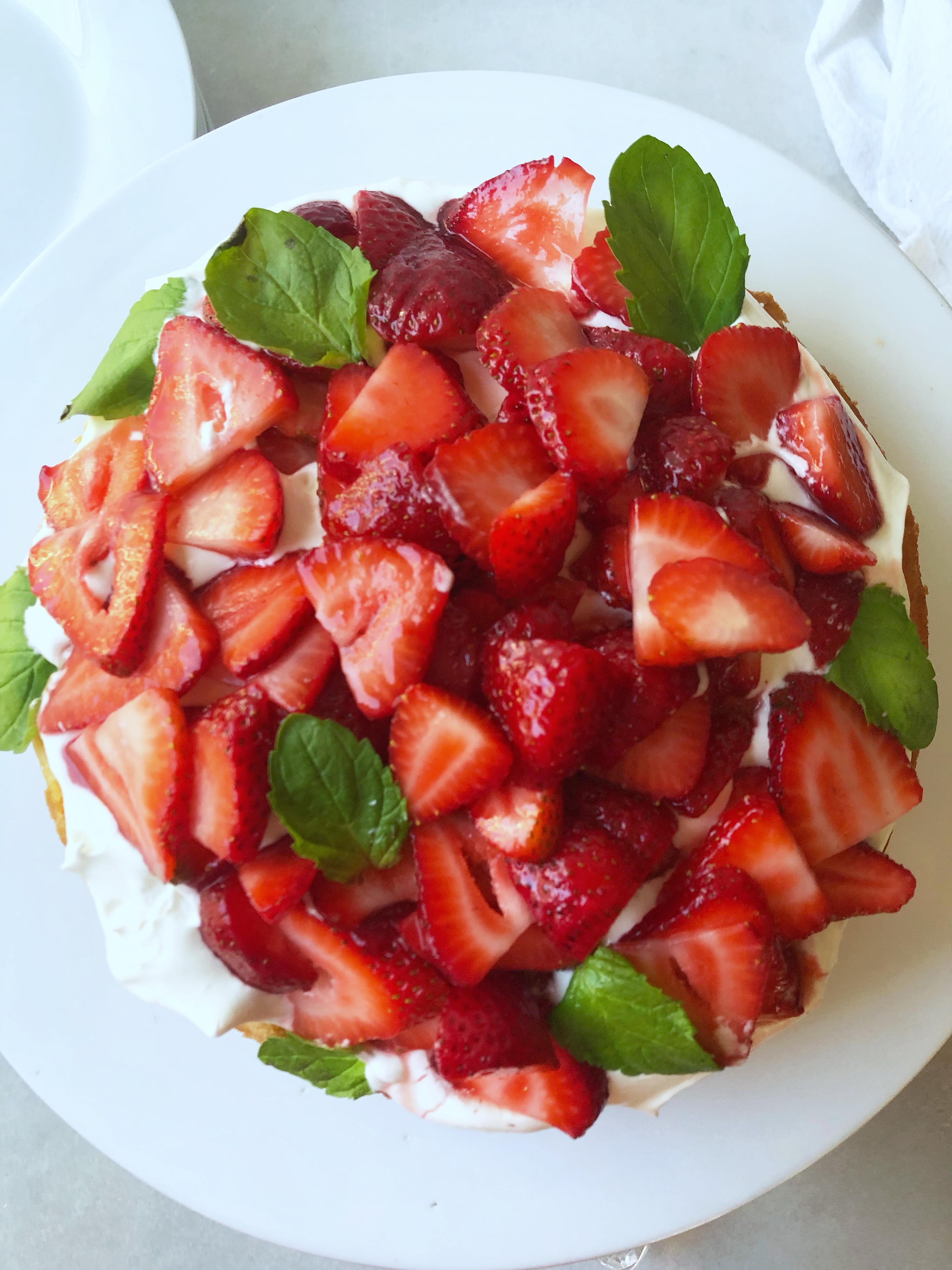 shortbread cake piled with fresh strawberries and whipped cream