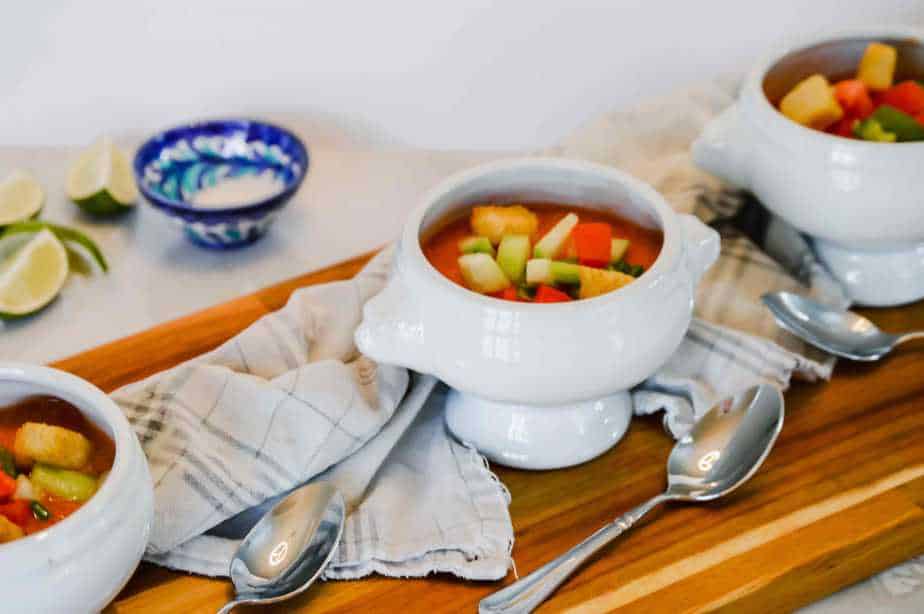 3 white bowls filled with Gazpacho, a cold soup from Spain