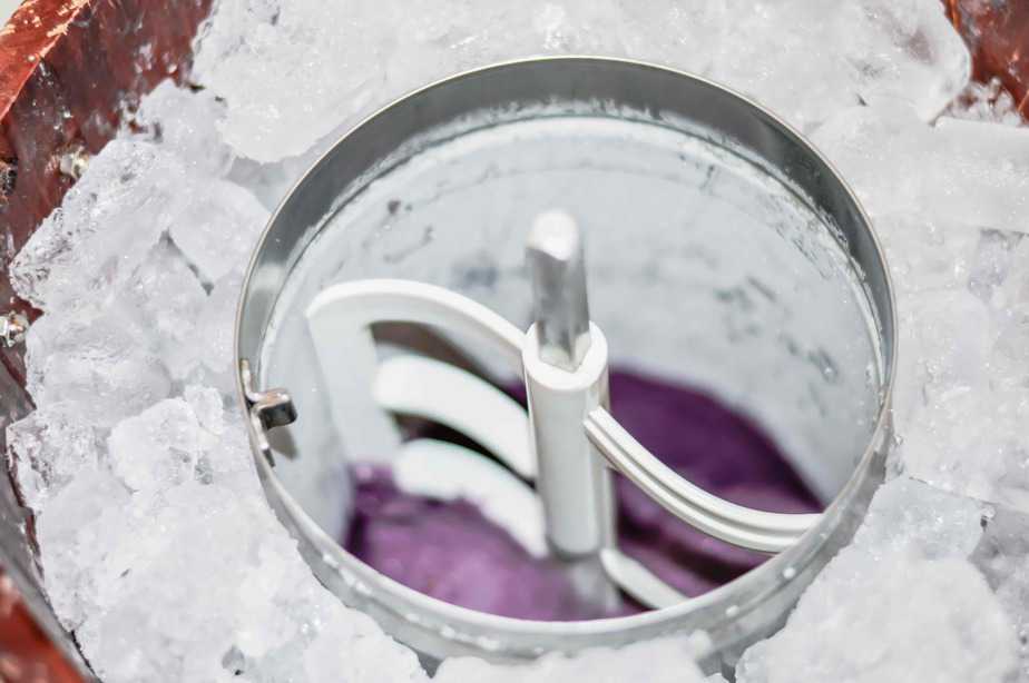 ice cream canister set in ice and filled with blackberry sherbet