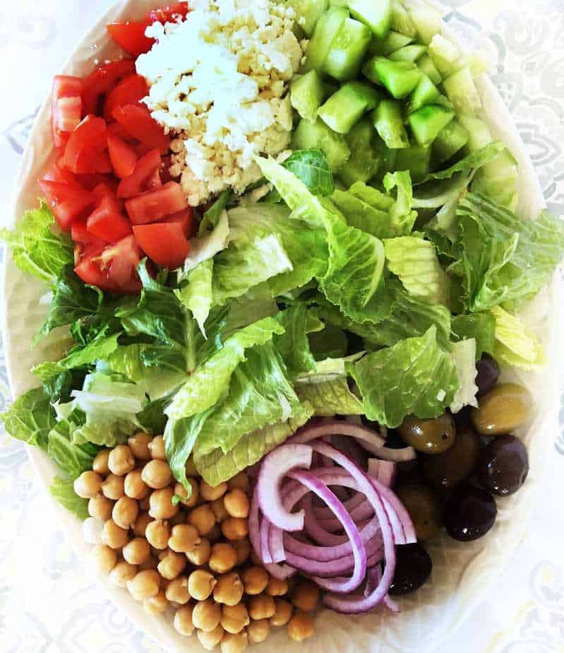 close up of platter filled with ingredients of Greek Salad