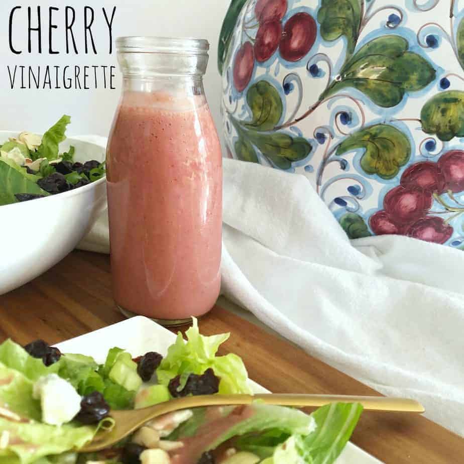 pink bottle of cherry vinaigrette with salad