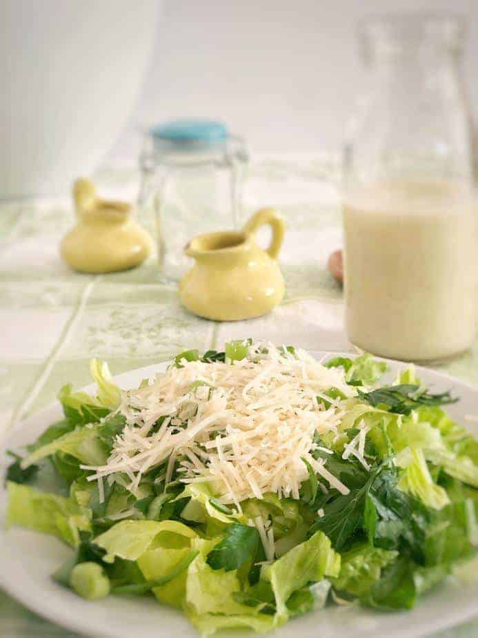 plate of Sensation Salad with two little yellow pitchers and bottle of dressing
