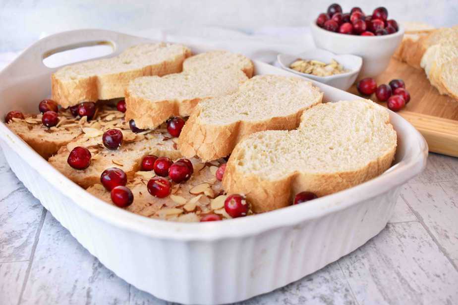 layering the bread for cranberry almond baked french toast