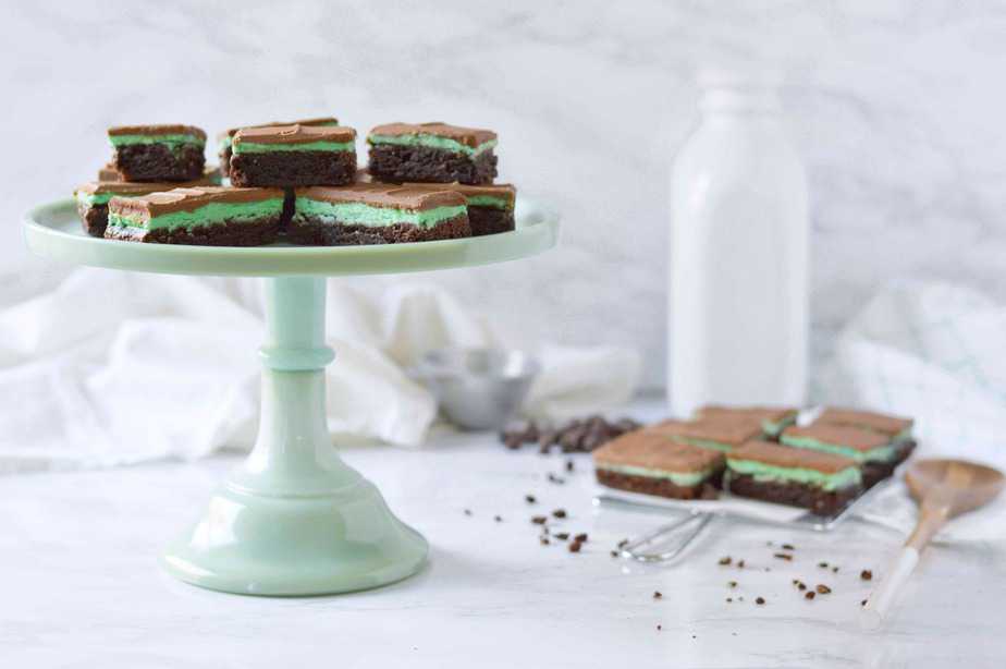 green cake stand filled with chocolate fudge mint brownies