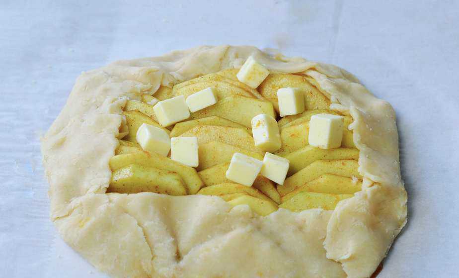 apple slices in pastry crust dotted with butter