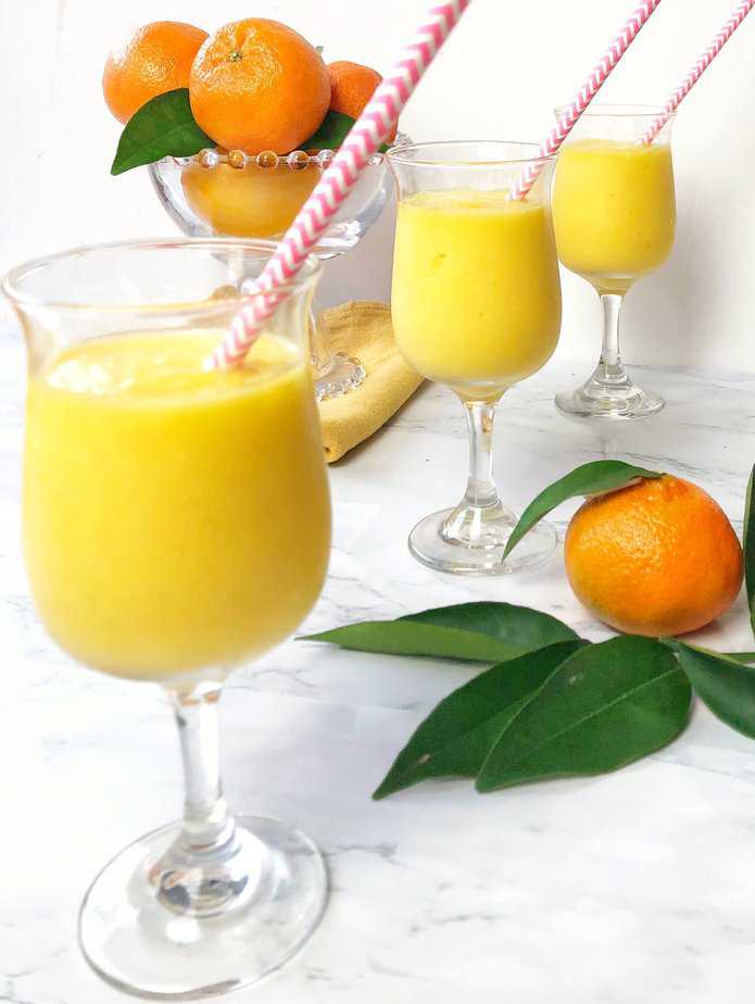 3 glasses filled with orange mango freeze