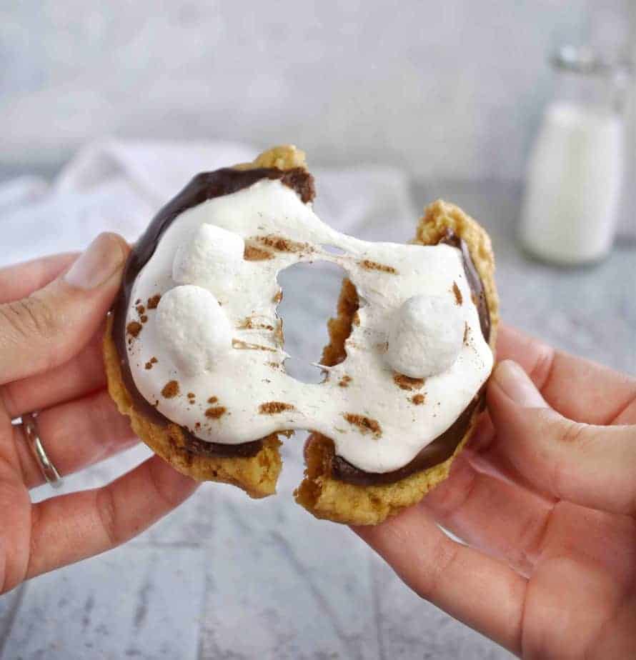 two hands pulling s'more cookie apart 