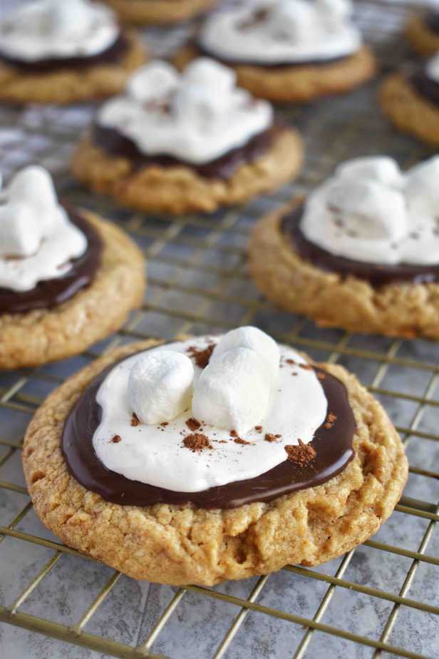 s'more cookie sitting on gold cooling rack with cookies in background