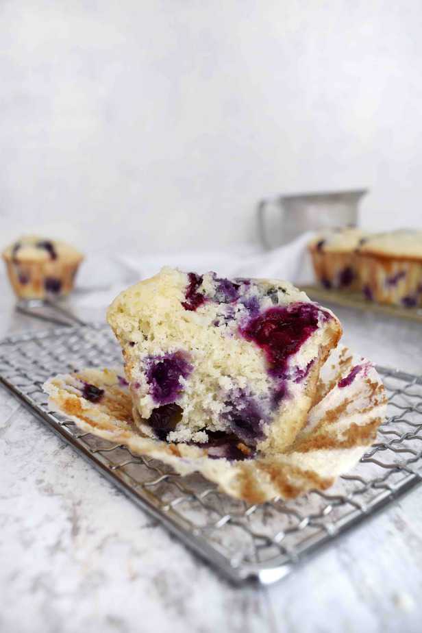 Blueberry muffin cut in half on small cooling rack