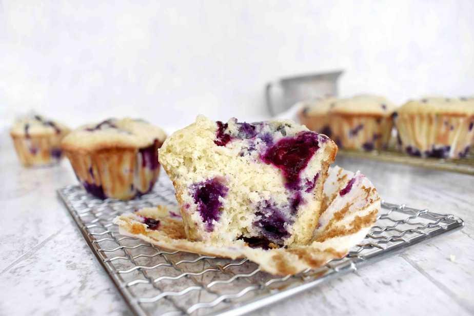 cut open blueberry muffin showing blueberries