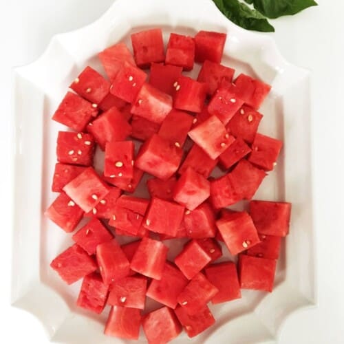 white platter with watermelon cubes. featured image