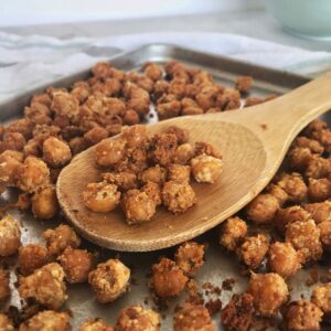 roasted chickpeas on a pan with wooden spoon