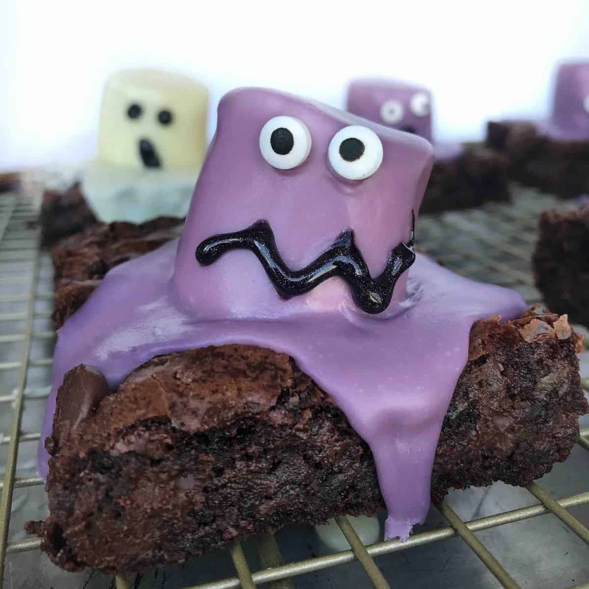 purple marshmallow monster on top of a brownie.