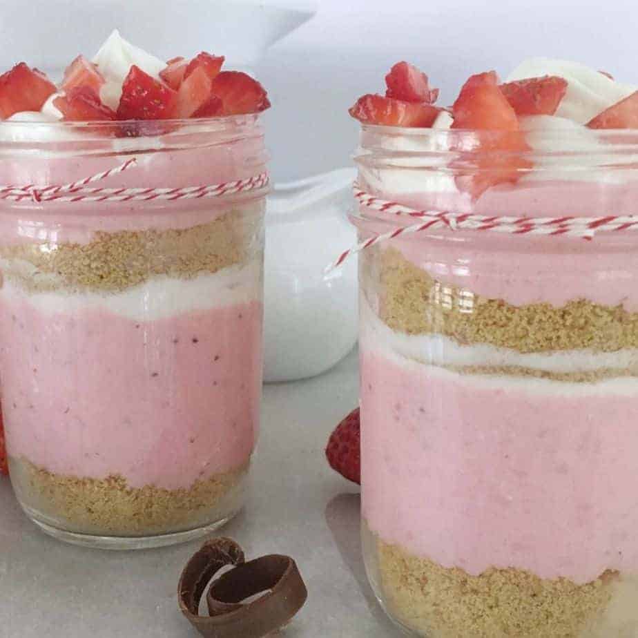 2 jars of layered strawberry cheesecake mousse parfaits
