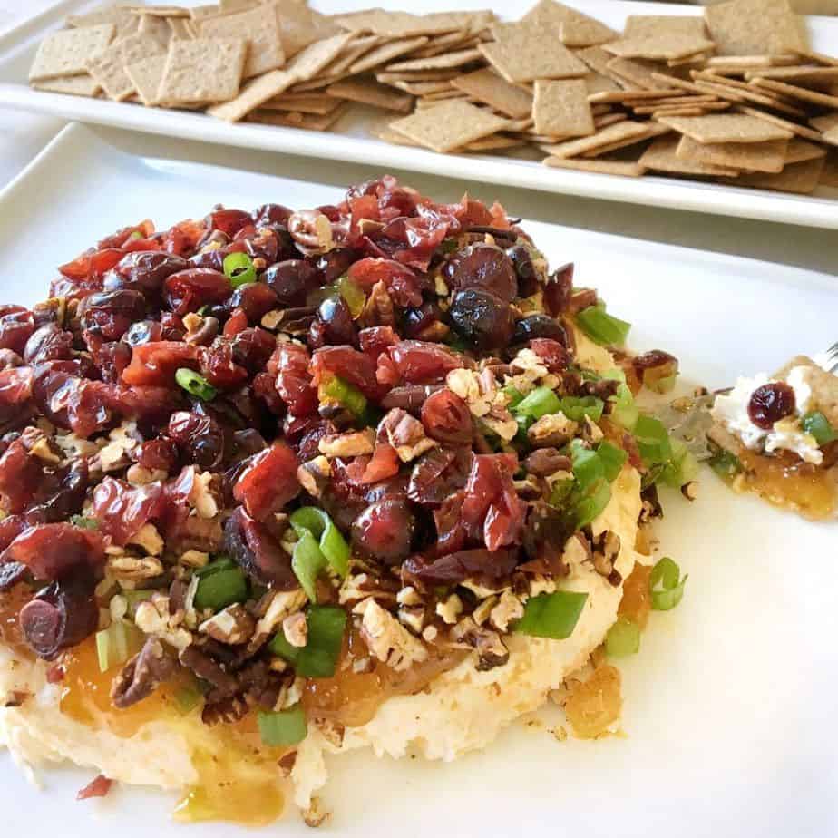 platter of holiday harvest spread with cream cheese, pecans, dried cranberries and apricot preserves