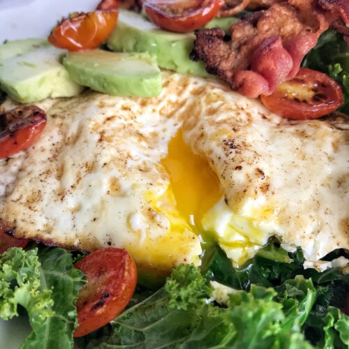 kale breakfast salad with runny yolk