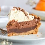 slice of chocolate orange pie on white plate. with fork