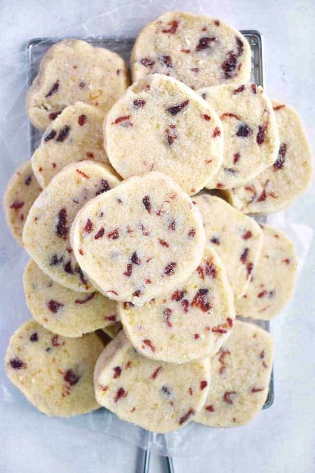 cranberry orange shortbread cookies stacked in a pile