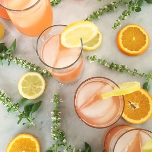 4 glasses filled with orange party punch. featured image.