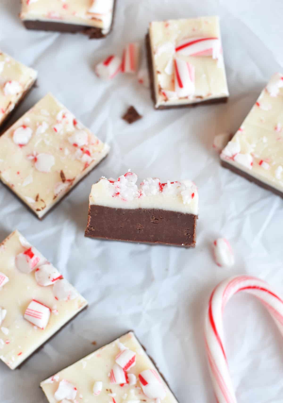 peppermint bark fudge square on its side with squares of fudge around it. 