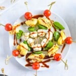 caprese skewers on white plate.