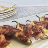 bacon wrapped jalapeno poppers on white tray