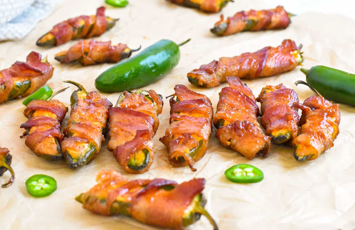 smoked jalapeno poppers lined up in a row.