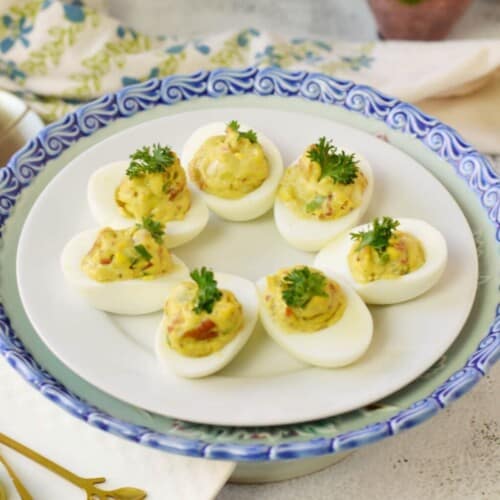 deviled eggs on white plate.