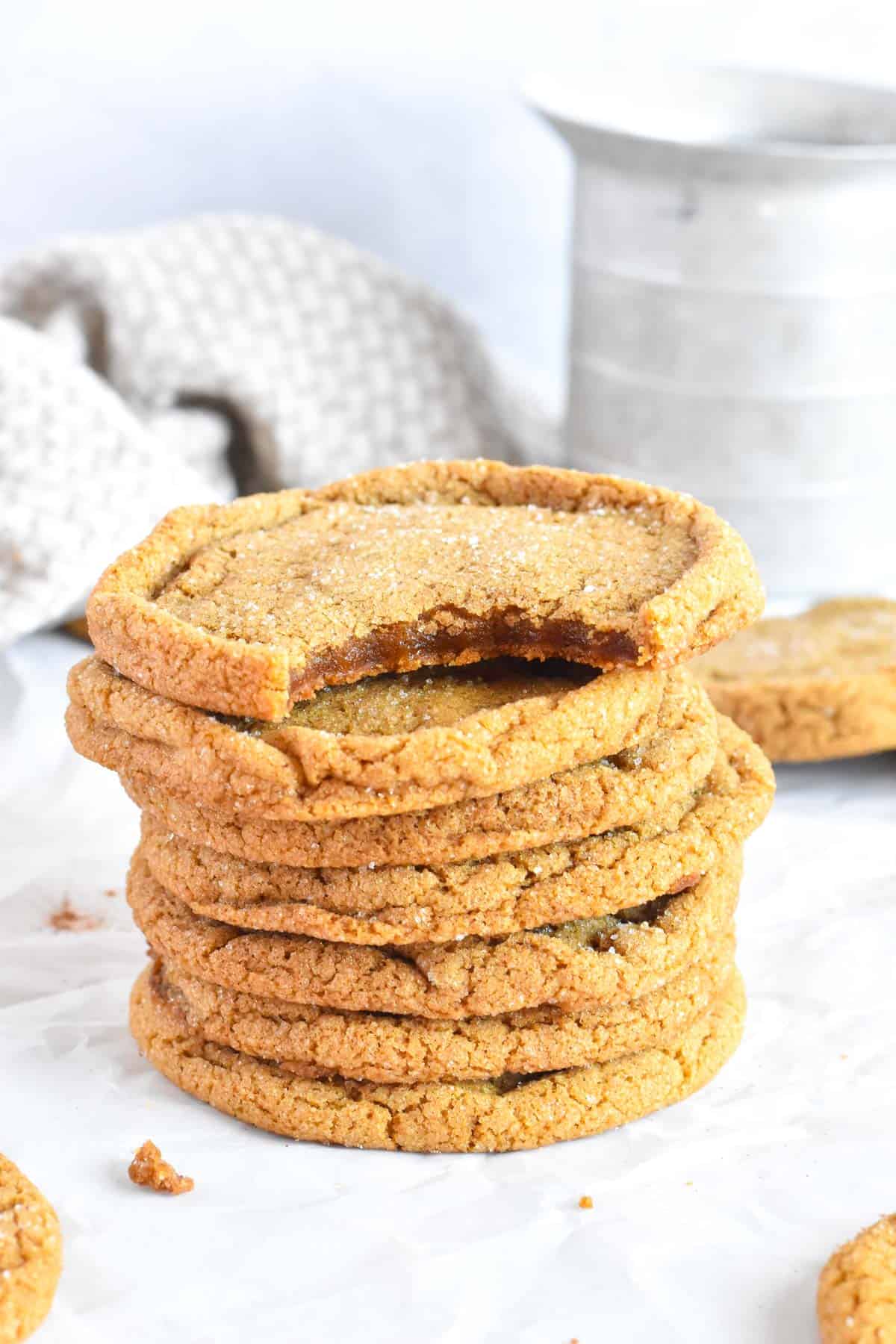 stack of molasses cookies, topped with one with a bite out of it.