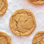 close up of molasses cookie on parchment paper.