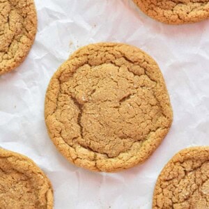 close up of molasses cookie on parchment paper.
