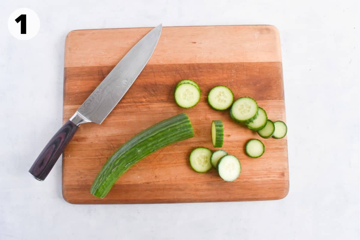 sliced cucumbers on cutting board. 