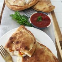 Title.Homemade Calzone cut open and on cutting board