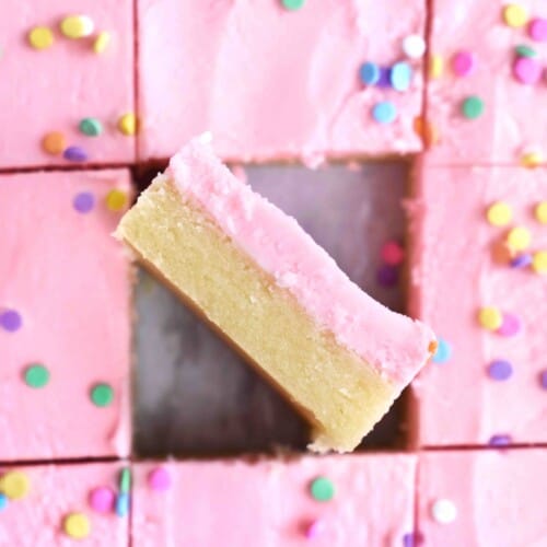 pink frosted sugar cookie bars with one on it's side