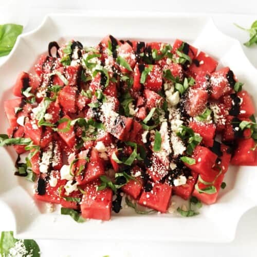 watermelon basil feta salad on white platter. featured image.