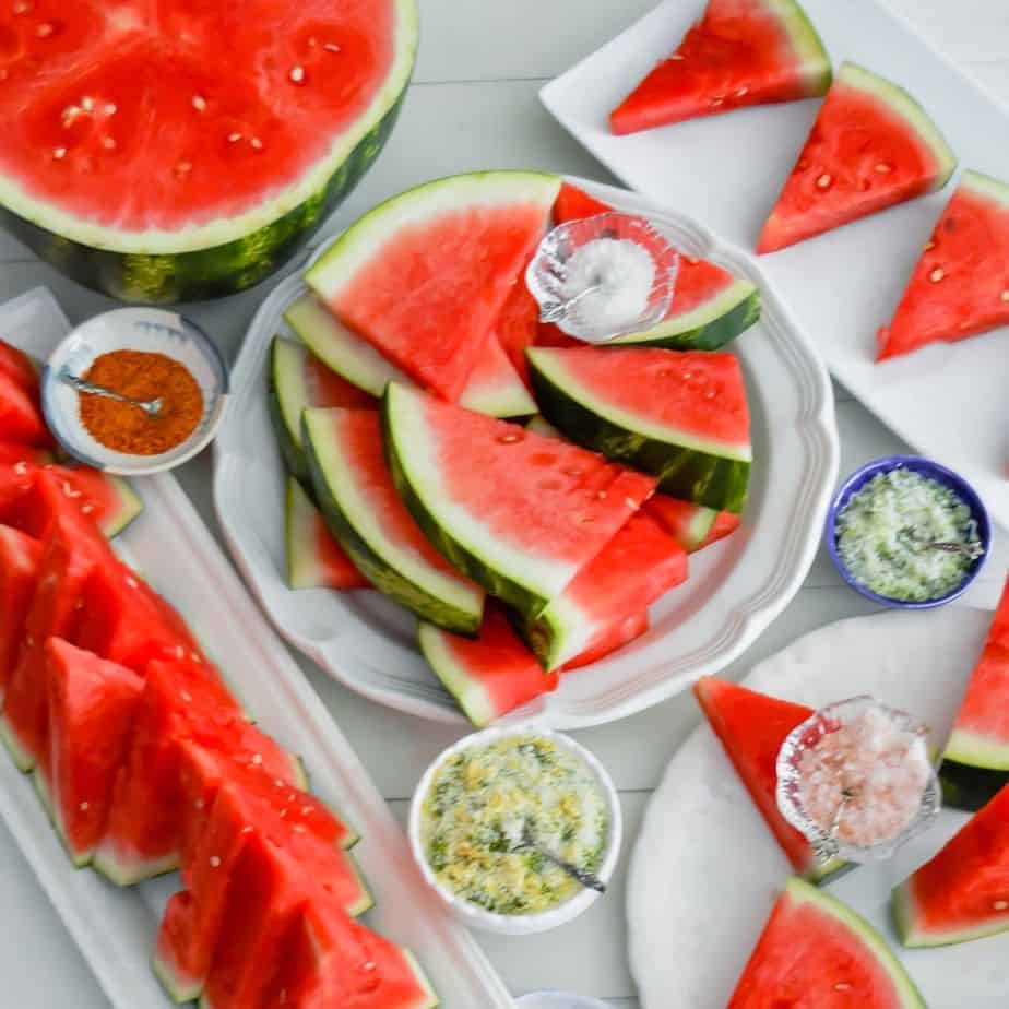lots of watermelon slices and little bowls of salt