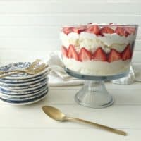 strawberry lemon trifle layered in a footed glass bowl