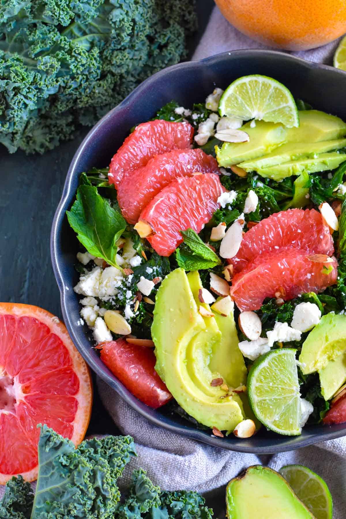 bowl with kale salad, grapefruit segments, and avocado.